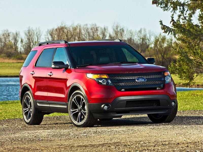 Red Ford Explorer parked by a lake