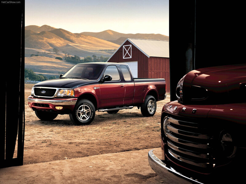 Red Ford F-150 truck at barn