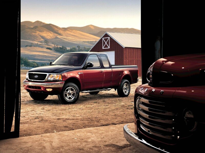 Red Ford F-150 truck in barnyard