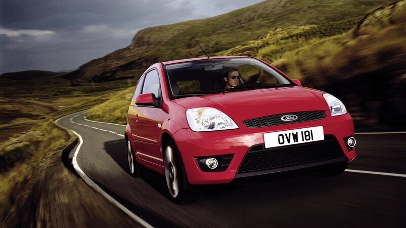 Red Ford Fiesta on a winding road