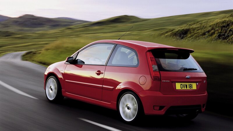 red ford fiesta on country road