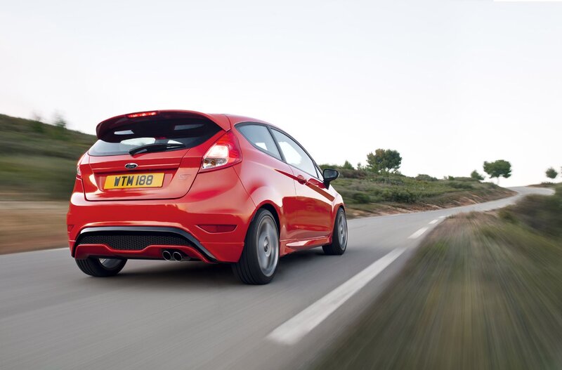 Red Ford Fiesta ST driving on road