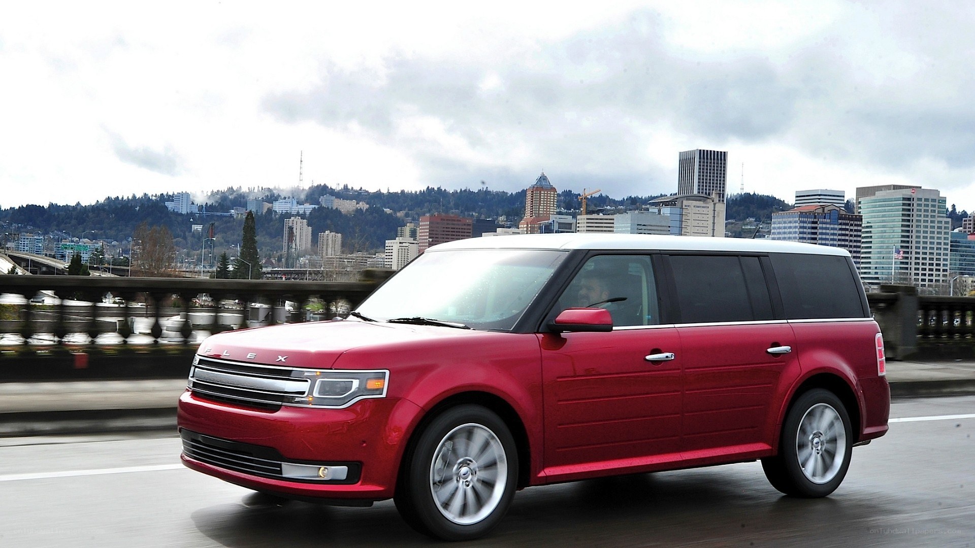Red Ford Flex on city bridge
