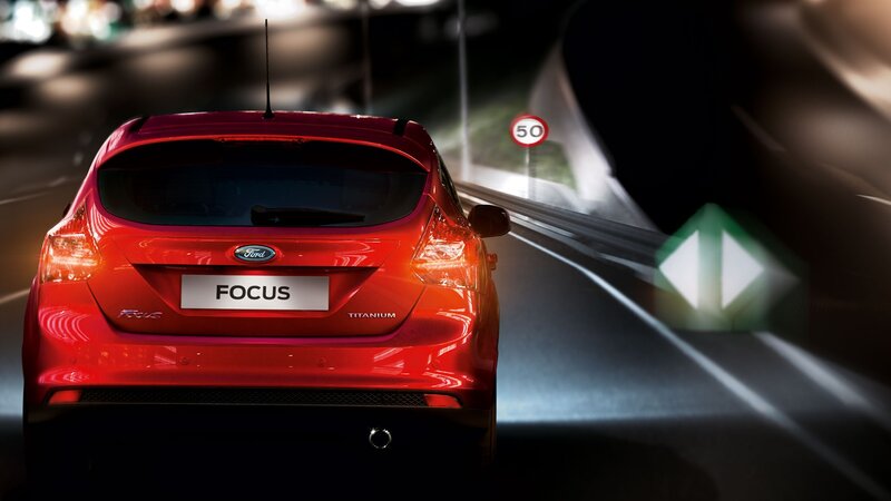 Red Ford Focus driving at night