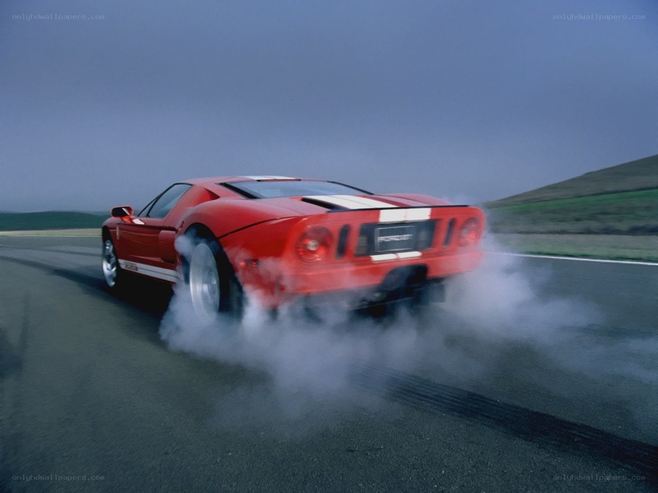 Red Ford GT burning rubber