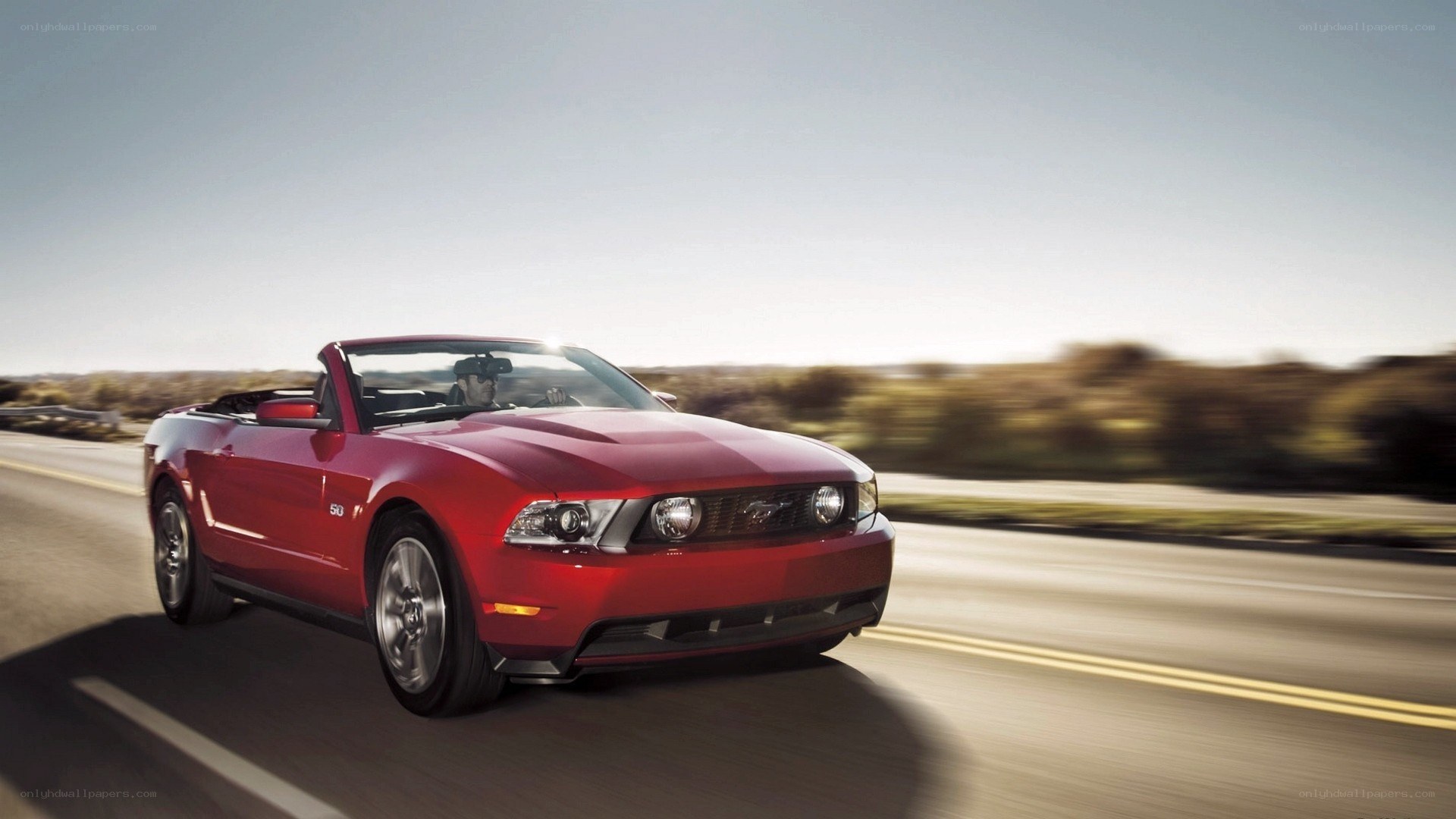 Red Ford Mustang convertible driving