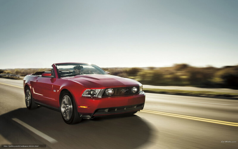 Red Ford Mustang convertible on road