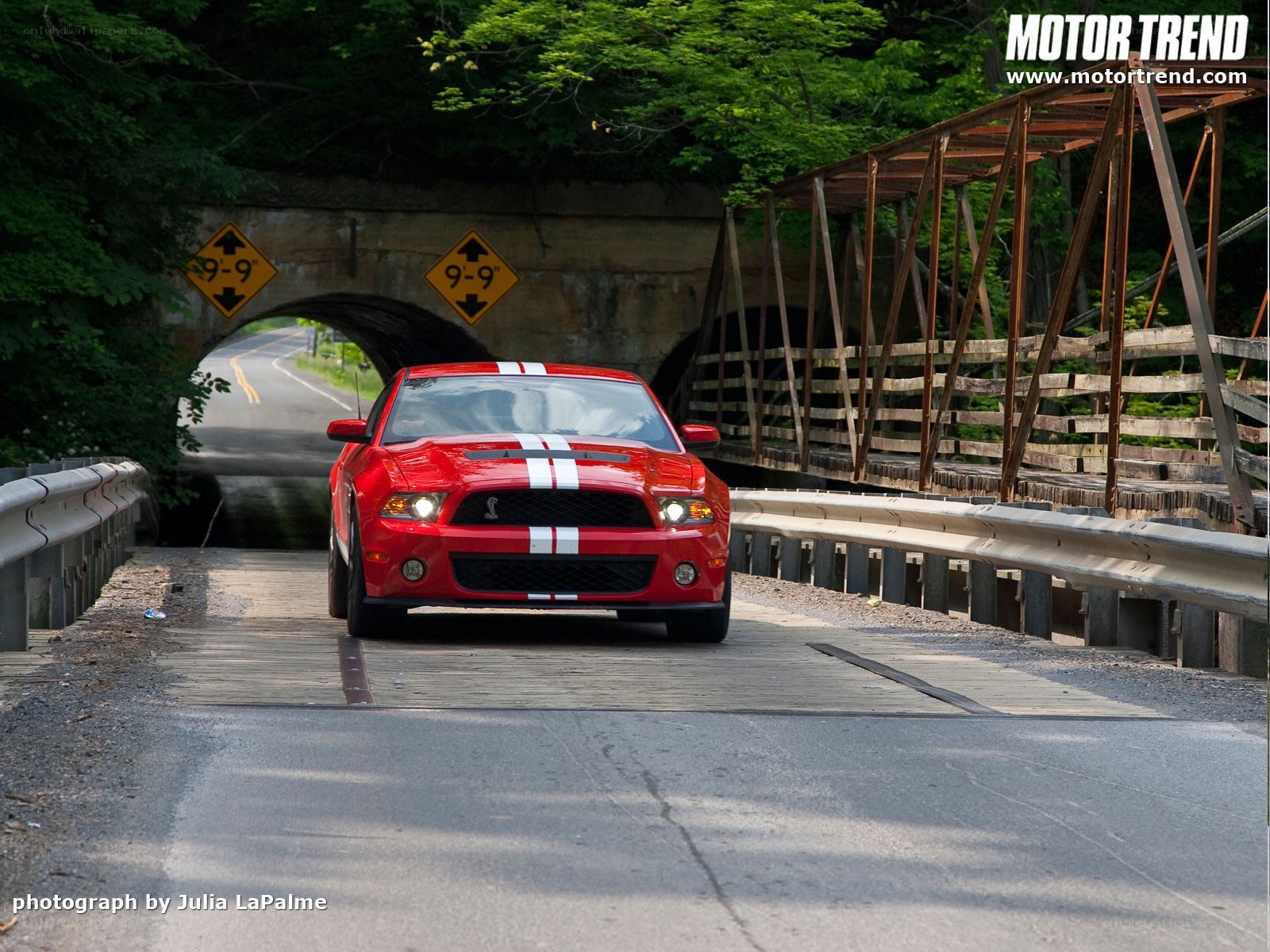 Red Ford Mustang on a bridge