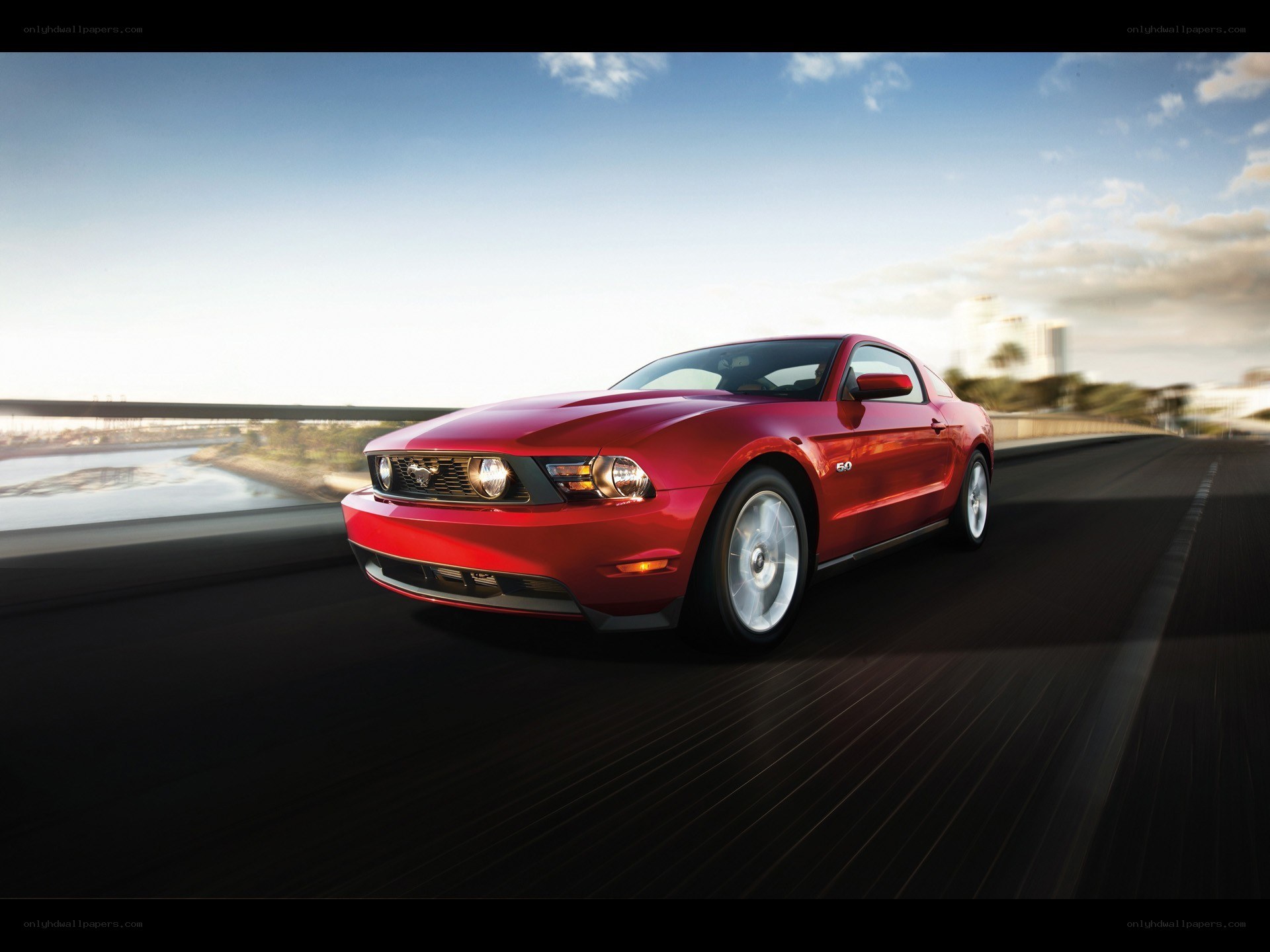Red Ford Mustang on a bridge