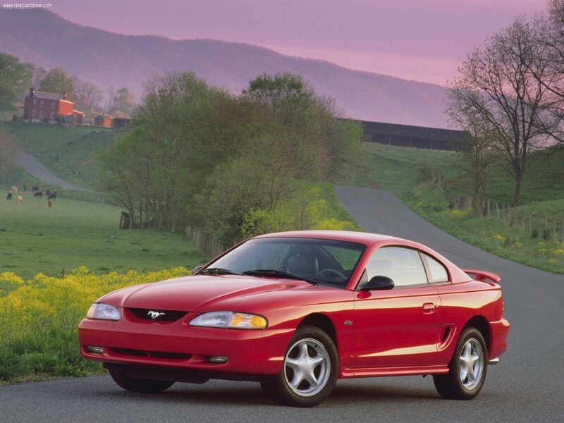 Red Ford Mustang on a country road