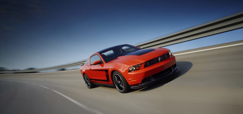 Red Ford Mustang on a highway