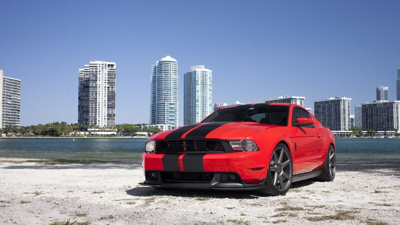 Red Ford Mustang on beach
