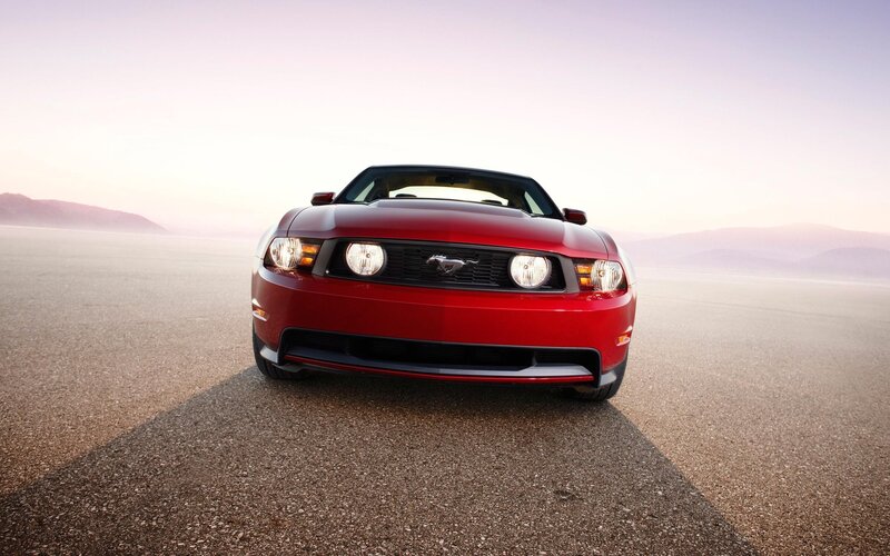 Red Ford Mustang on desert road