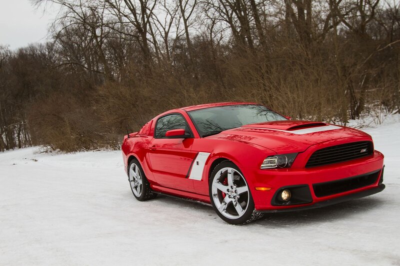 Red Ford Mustang on snowy road