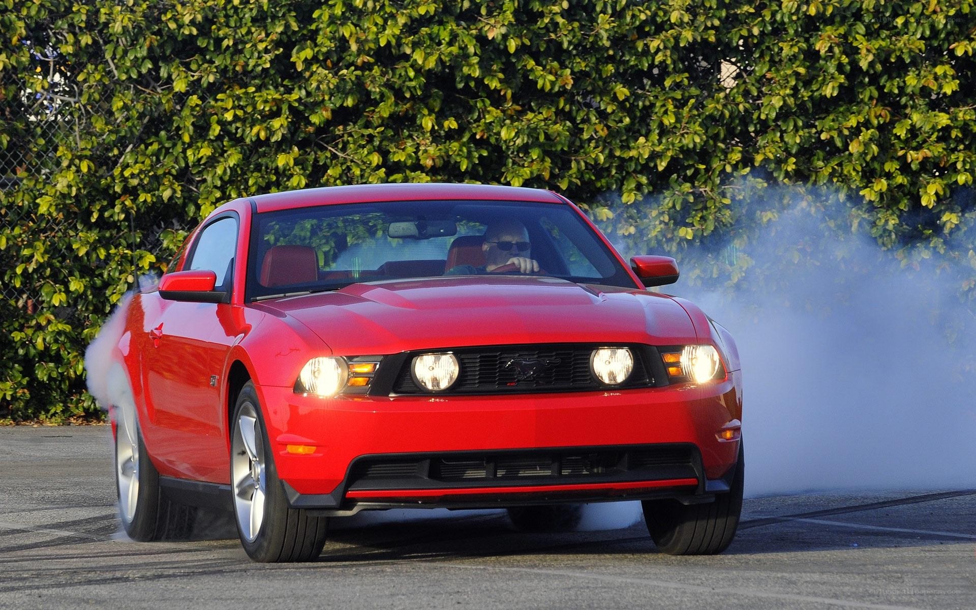 Red Ford Mustang performing burnout