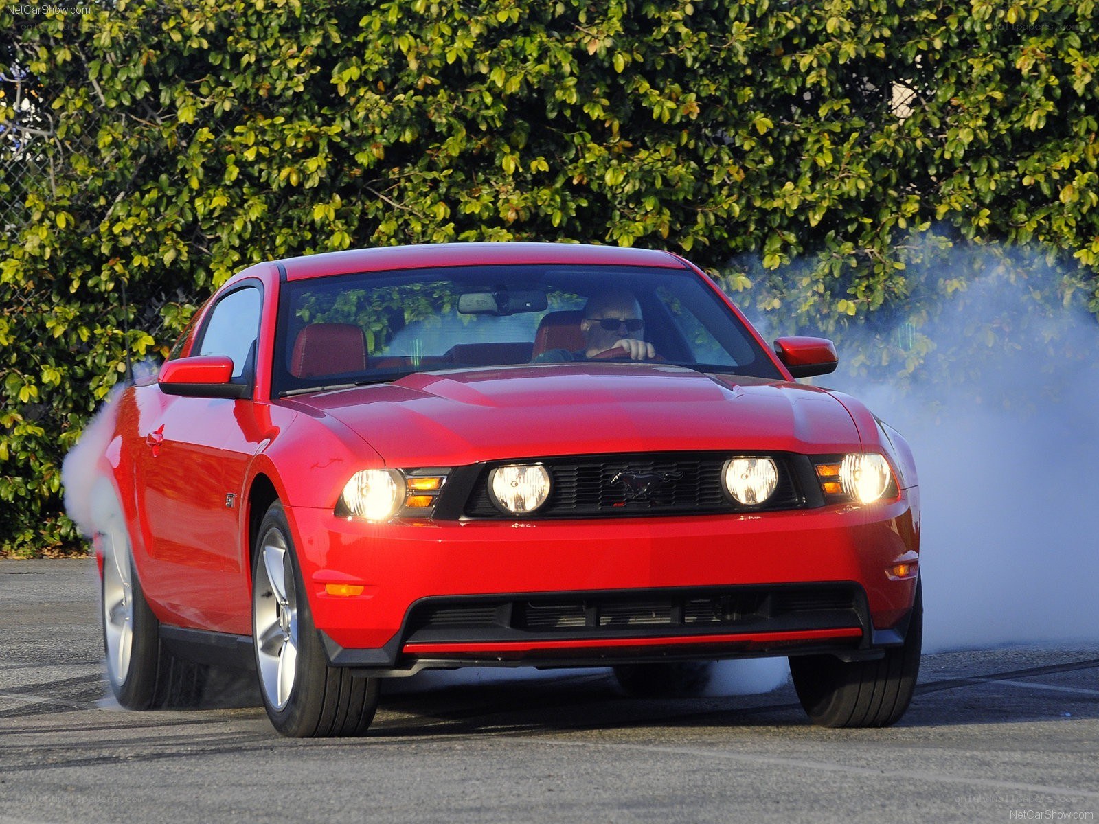 Red Ford Mustang performing burnout