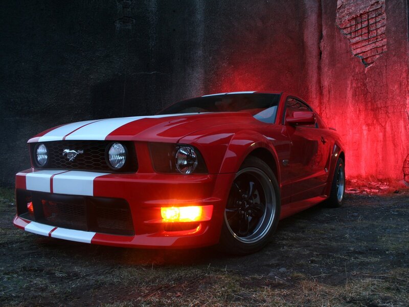 Red Ford Mustang with racing stripes