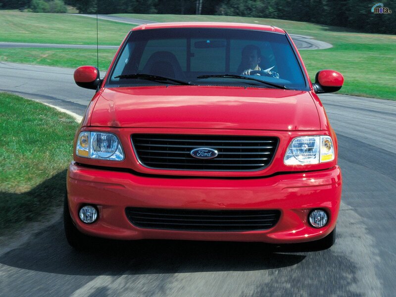 red ford pickup truck on road