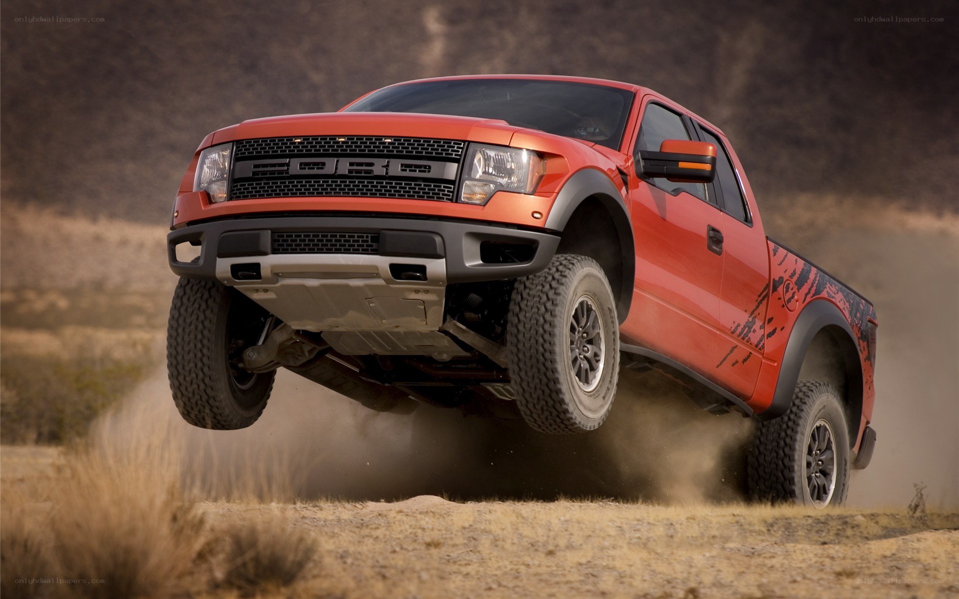 Red Ford Raptor in action