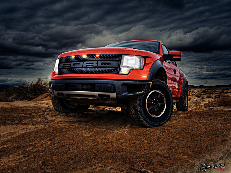 Red Ford Raptor in desert