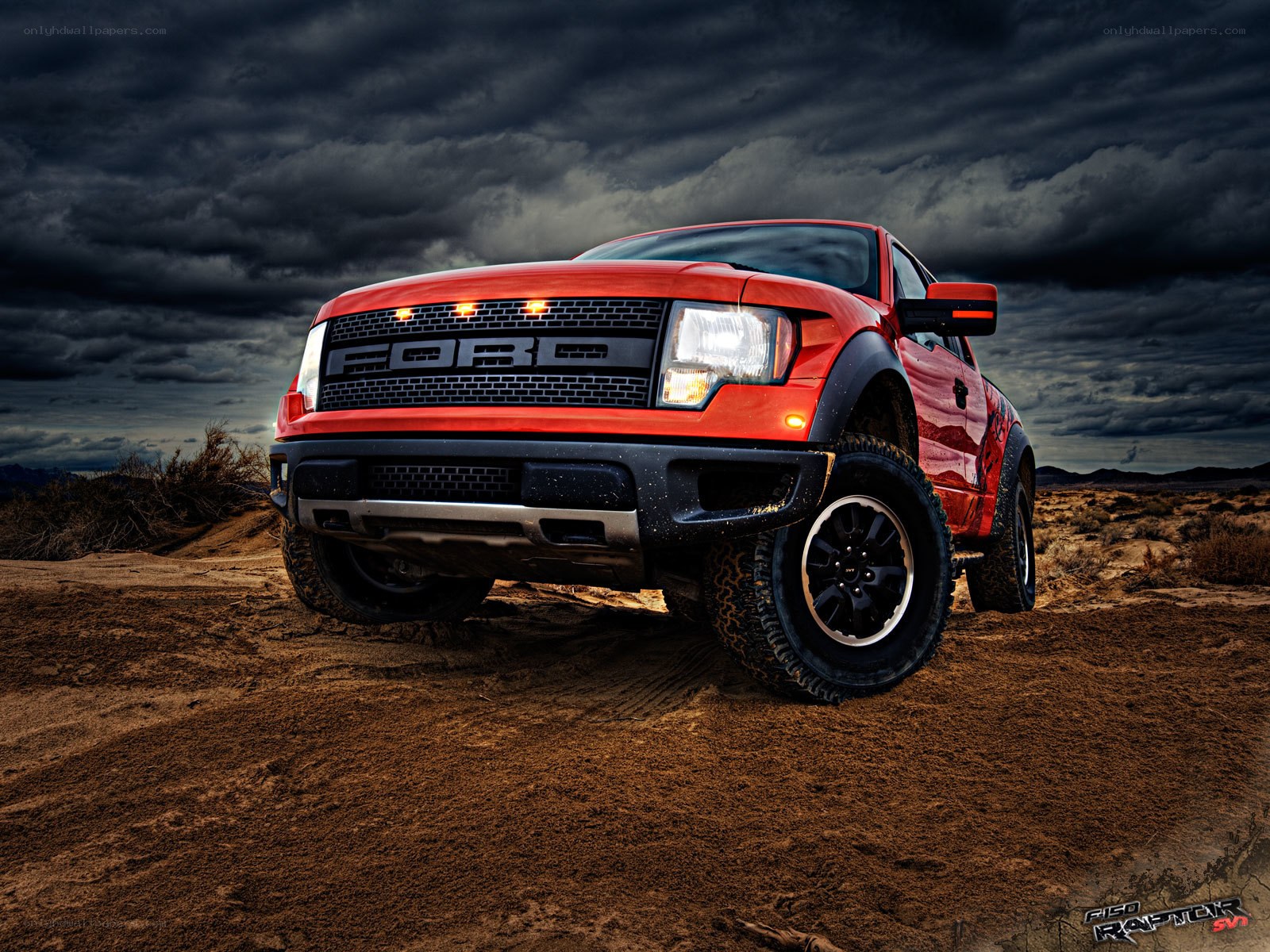 Red Ford Raptor in desert
