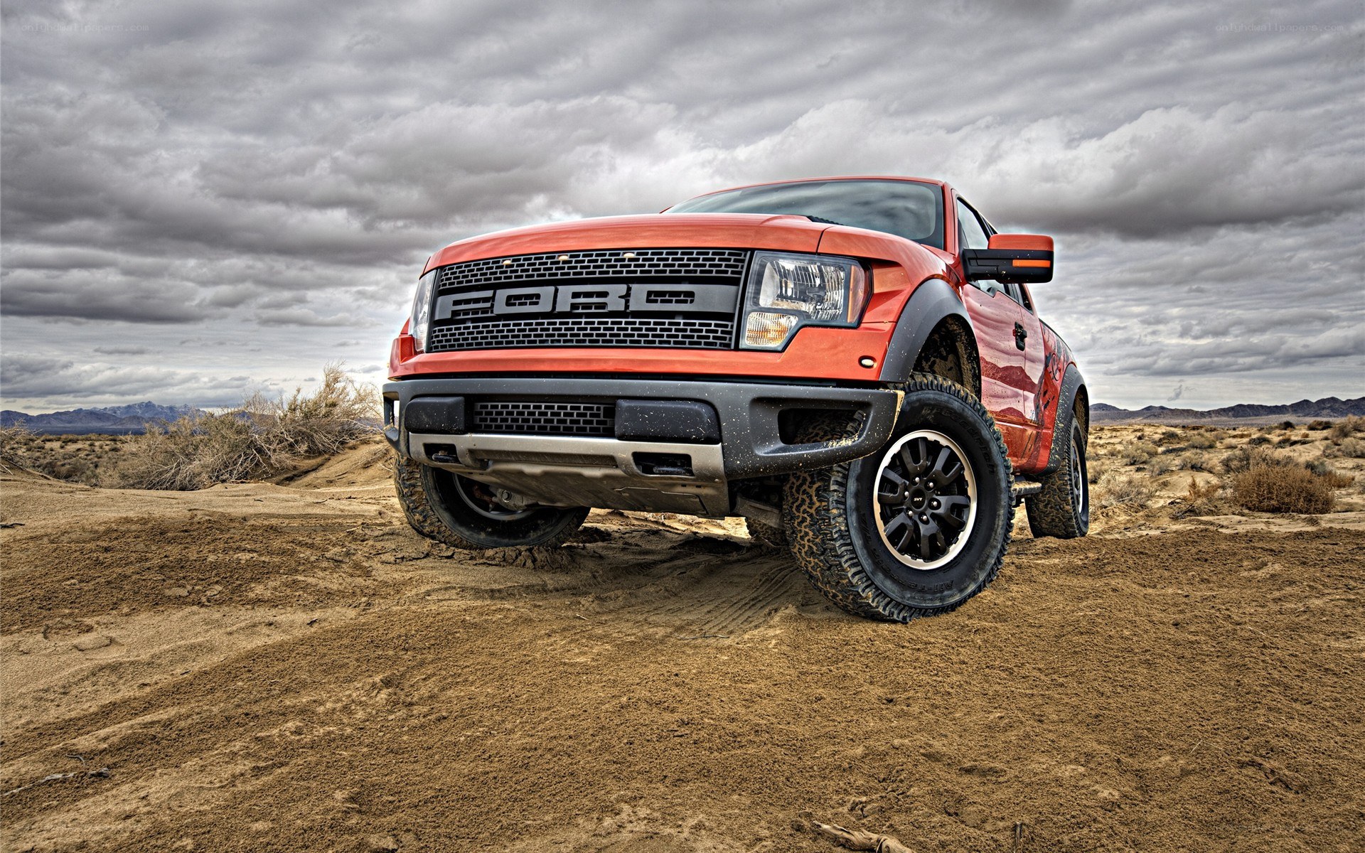 red ford raptor in desert
