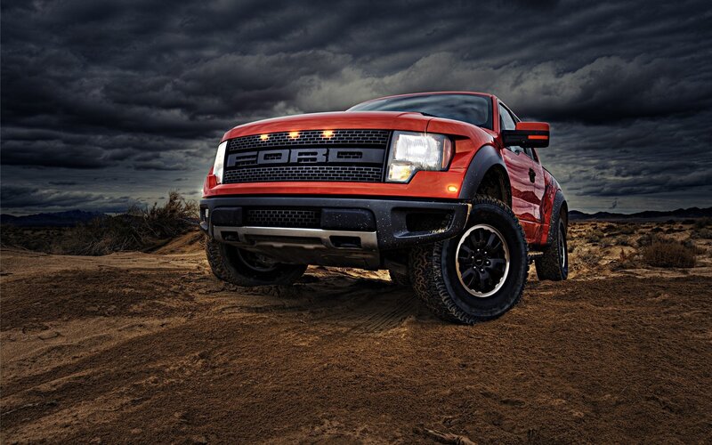 Red Ford Raptor in desert