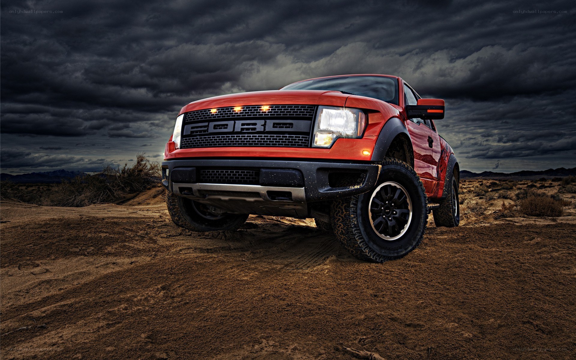 Red Ford Raptor in desert