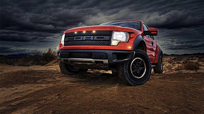 Red Ford Raptor in desert