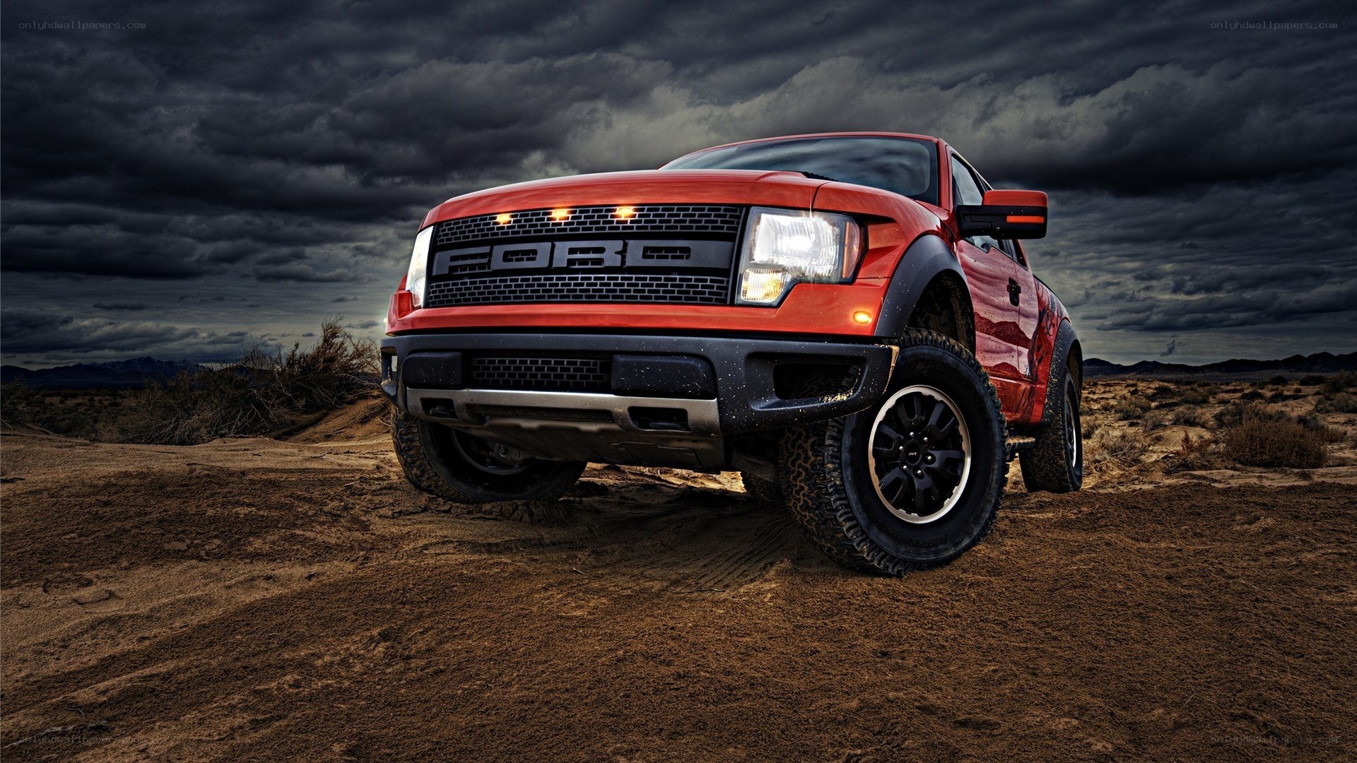 Red Ford Raptor in desert