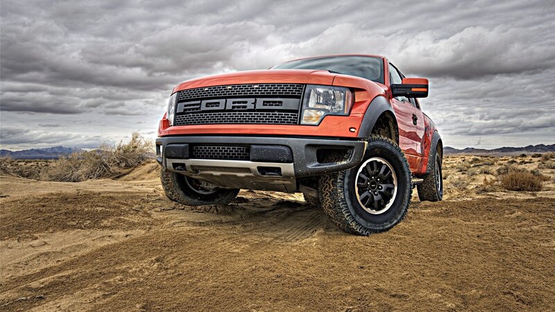 Red Ford Raptor in desert