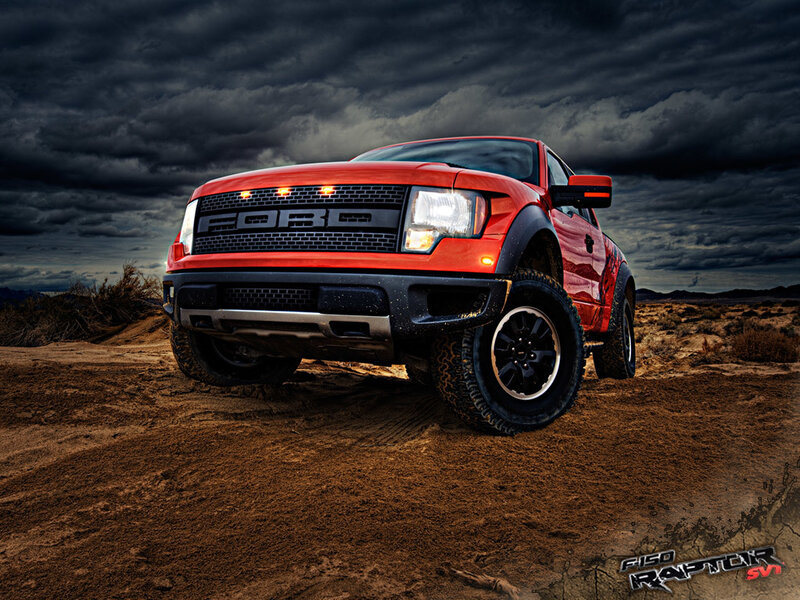 Red Ford Raptor in desert