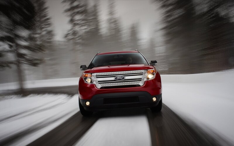 Red Ford SUV on snowy road