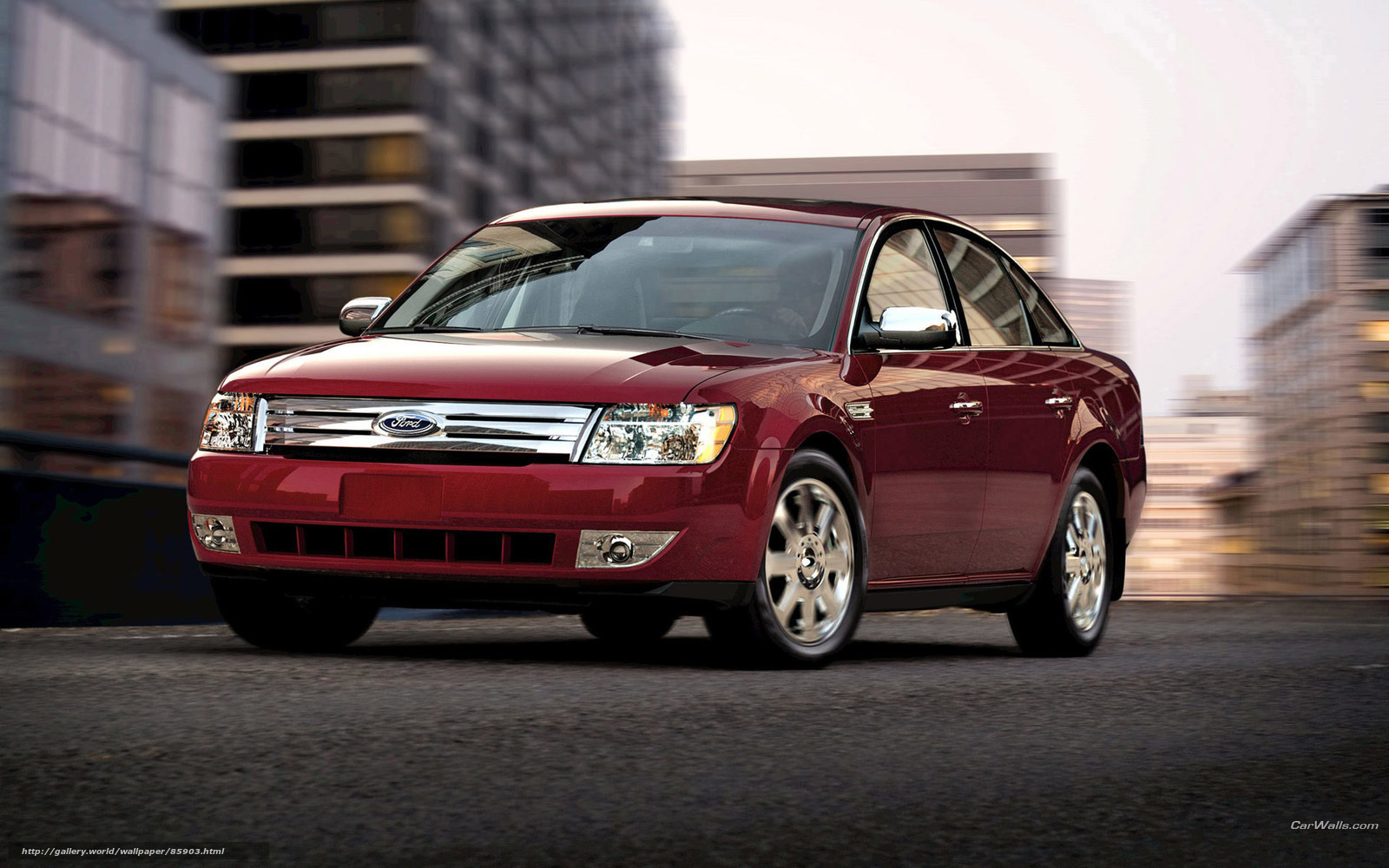 Red Ford Taurus in city