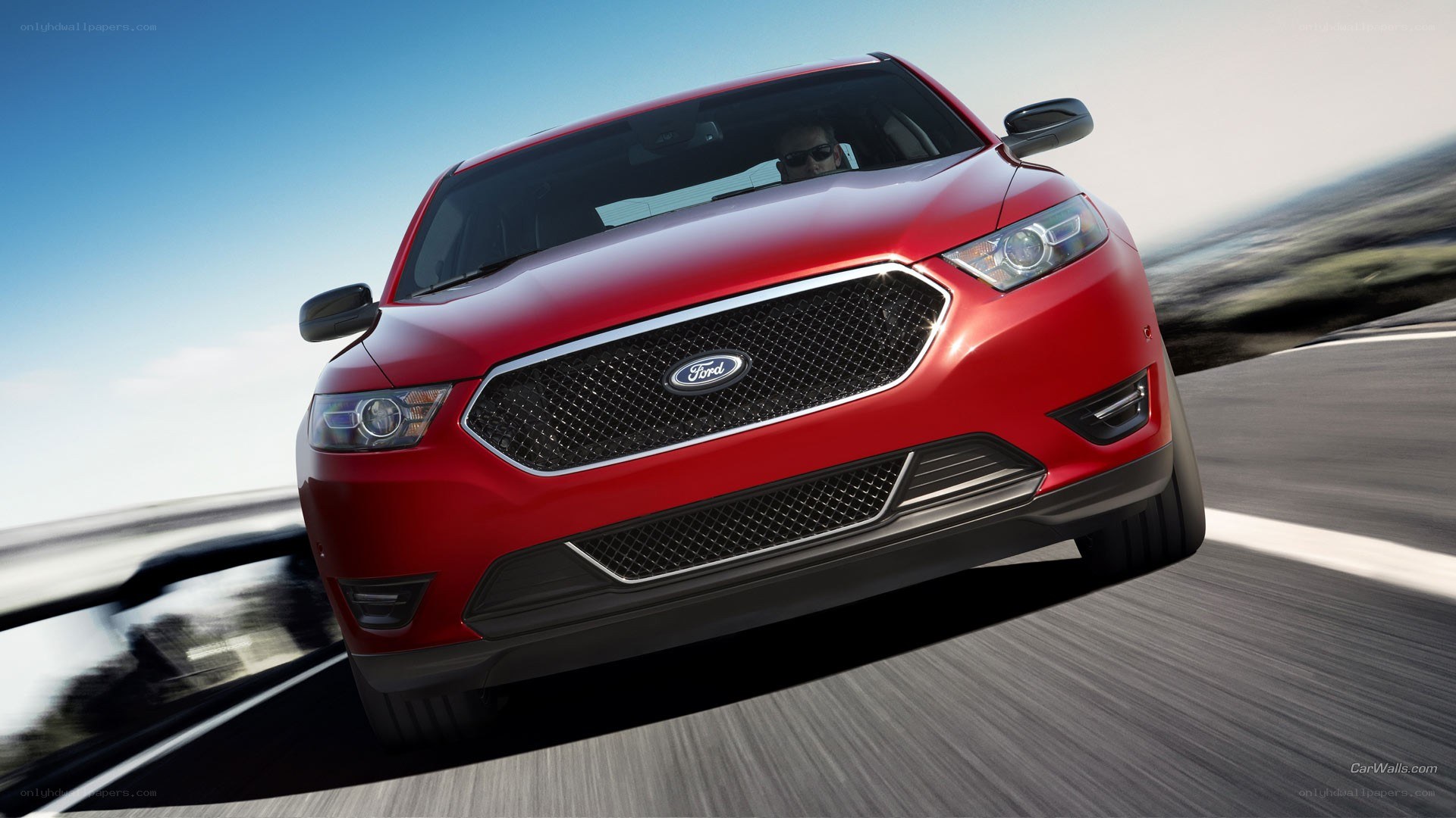 Red Ford Taurus in motion