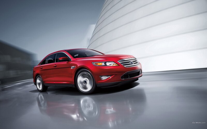 Red Ford Taurus in motion