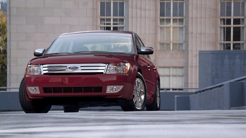 Red Ford Taurus parked on rooftop