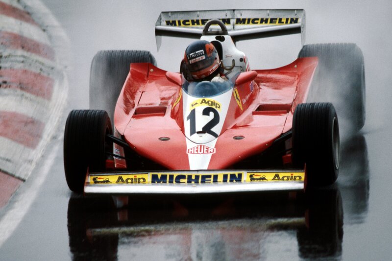 Red Formula 1 car on wet track