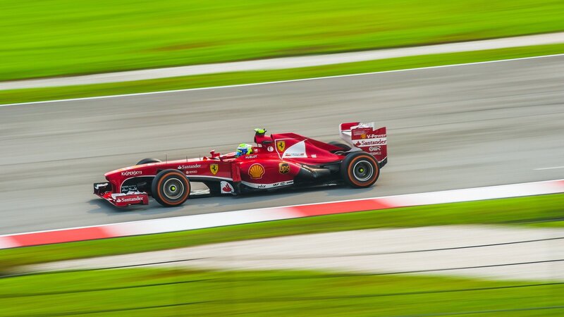 Red Formula One Car — Dynamic, Afternoon, Photograph, Driver, Race Track, Grass, Green