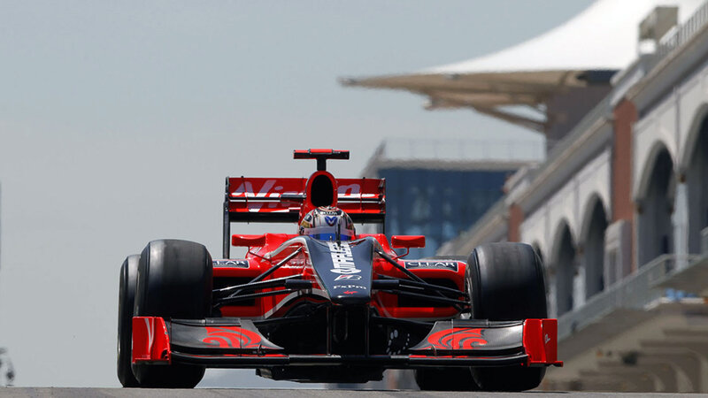 Red Formula One Car — Dynamic, Afternoon, Photograph, Driver, Racetrack, Building
