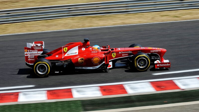 Red Formula One Car — Dynamic, Afternoon, Photograph, Driver, Racetrack, Safety Barrier
