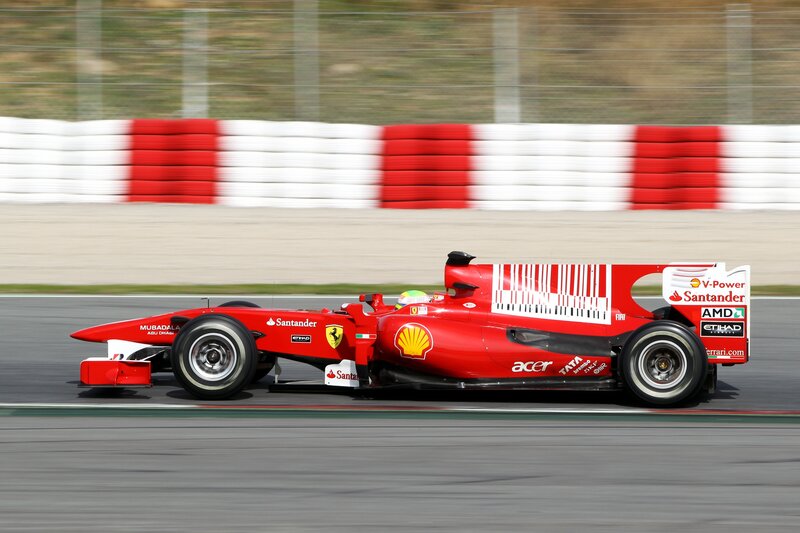 Red Formula One Car — Dynamic, Afternoon, Photograph, Driver, Tires, Safety Barrier