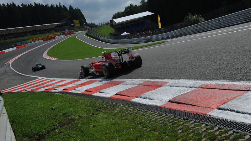 Red Formula One Car — Dynamic, Afternoon, Photograph, Race Track, Grass