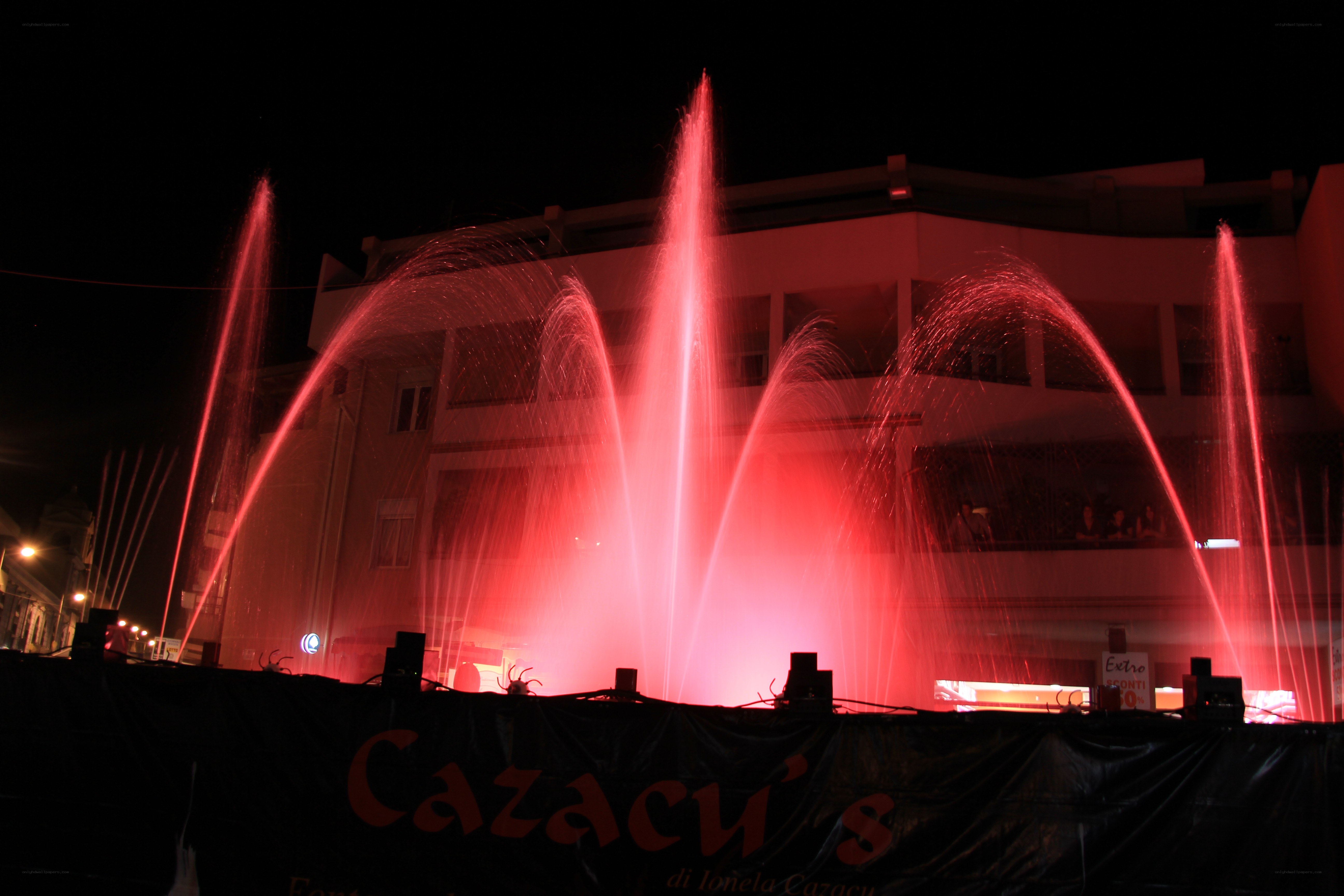Red fountain display at night