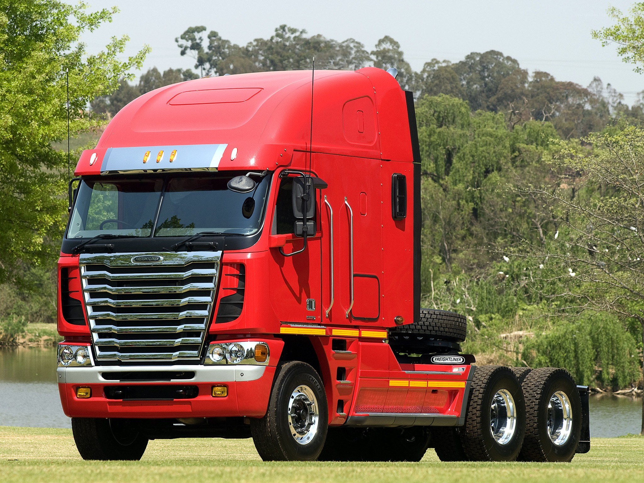 Red Freightliner truck on grass