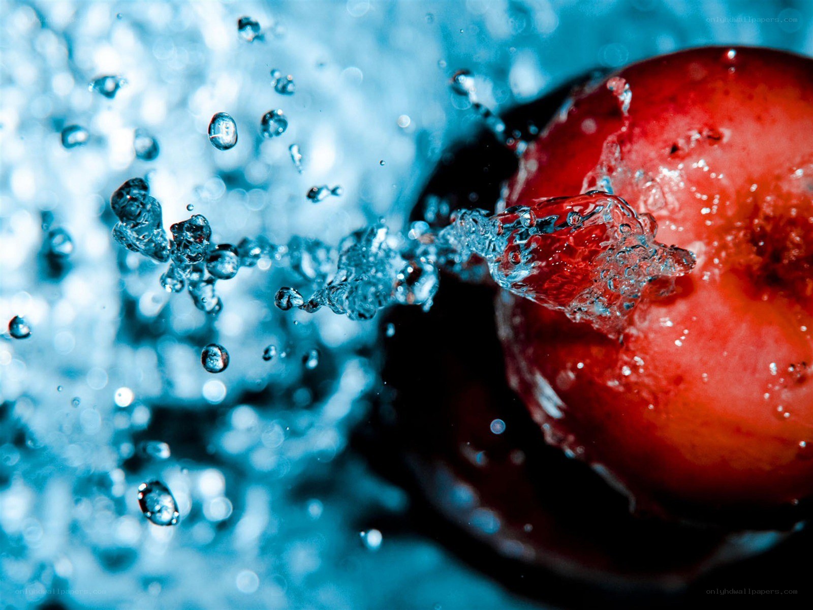 Red fruit splashing in water
