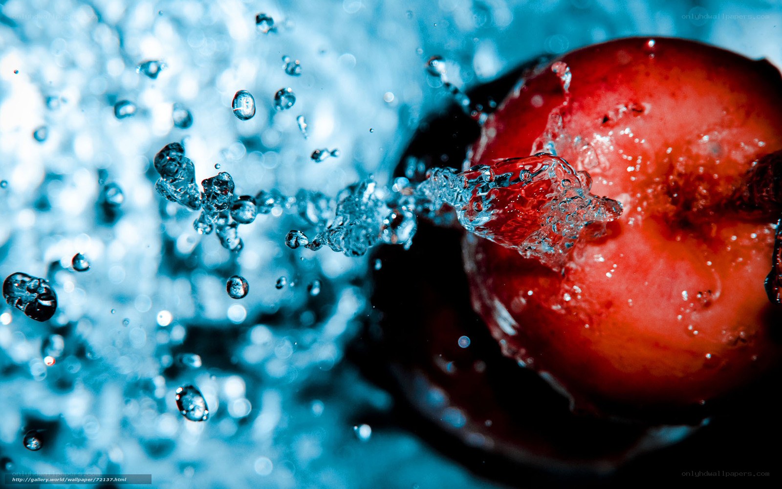 Red fruit splashing in water