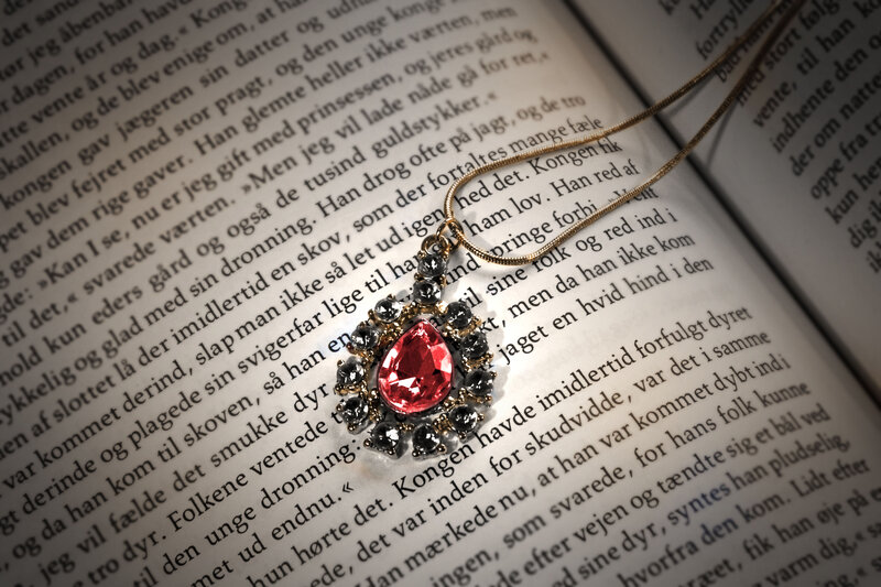 Red Gem Necklace on Book