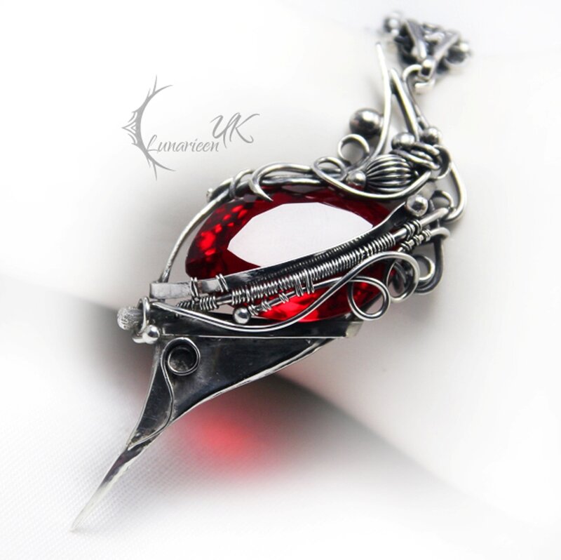 Red Gemstone Pendant — Dramatic, Photograph
