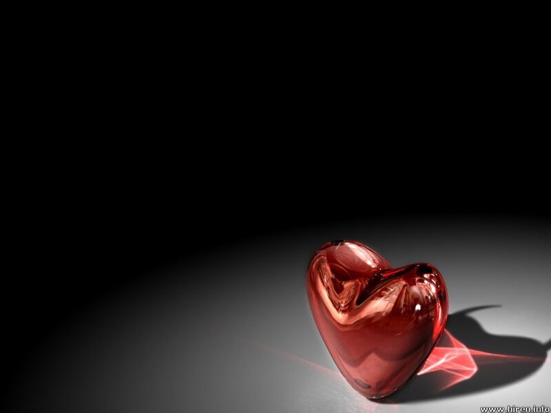Red glass heart on dark background